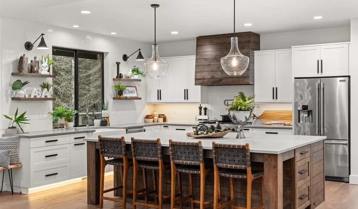 Custom kitchen design in Olympia, WA with white cabinetry, large wood island, and pendant lighting