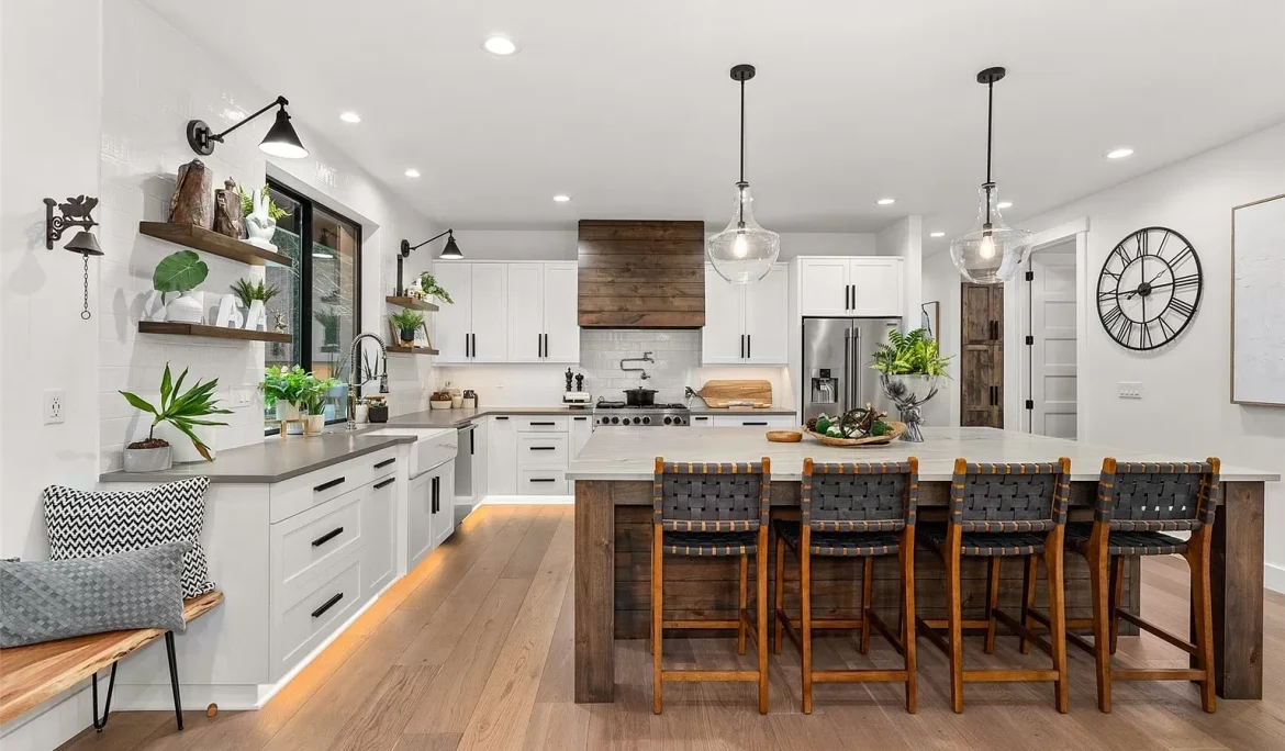 Open-concept kitchen with oversized island, mixed wood and white cabinetry, designed in Olympia, Washington