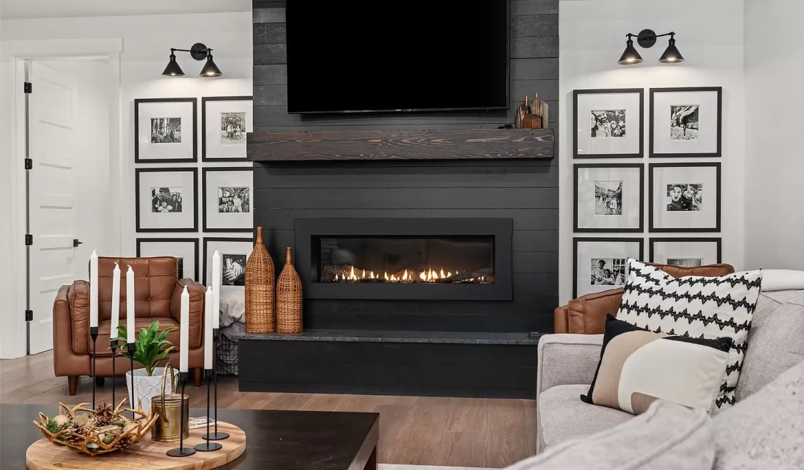 Black fireplace with wood mantel, framed artwork, and modern accent lighting