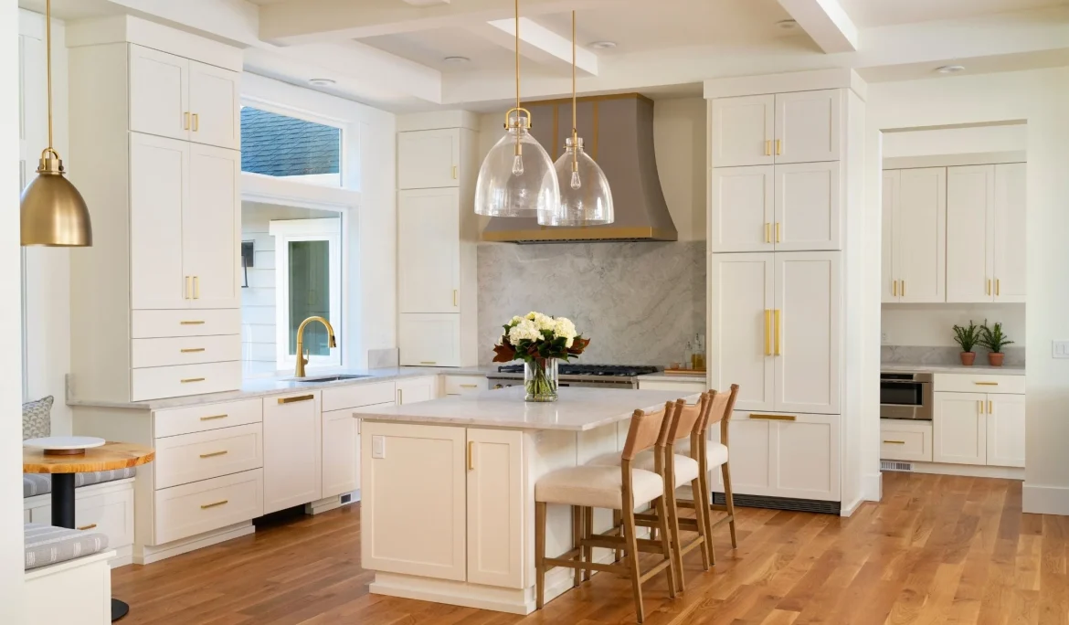 Bright white kitchen at Sound View Estate featuring custom metal hood and white oak flooring in Olympia, WA