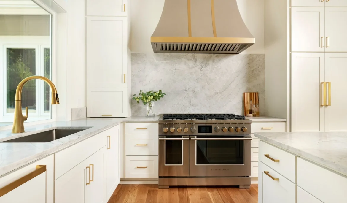 Custom fabricated metal kitchen hood and natural stone backsplash at Sound View Estate in Olympia, WA