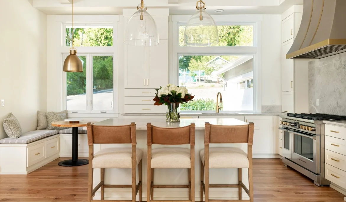 Kitchen island with integrated seating and pendant lighting at Sound View Estate in Olympia, WA