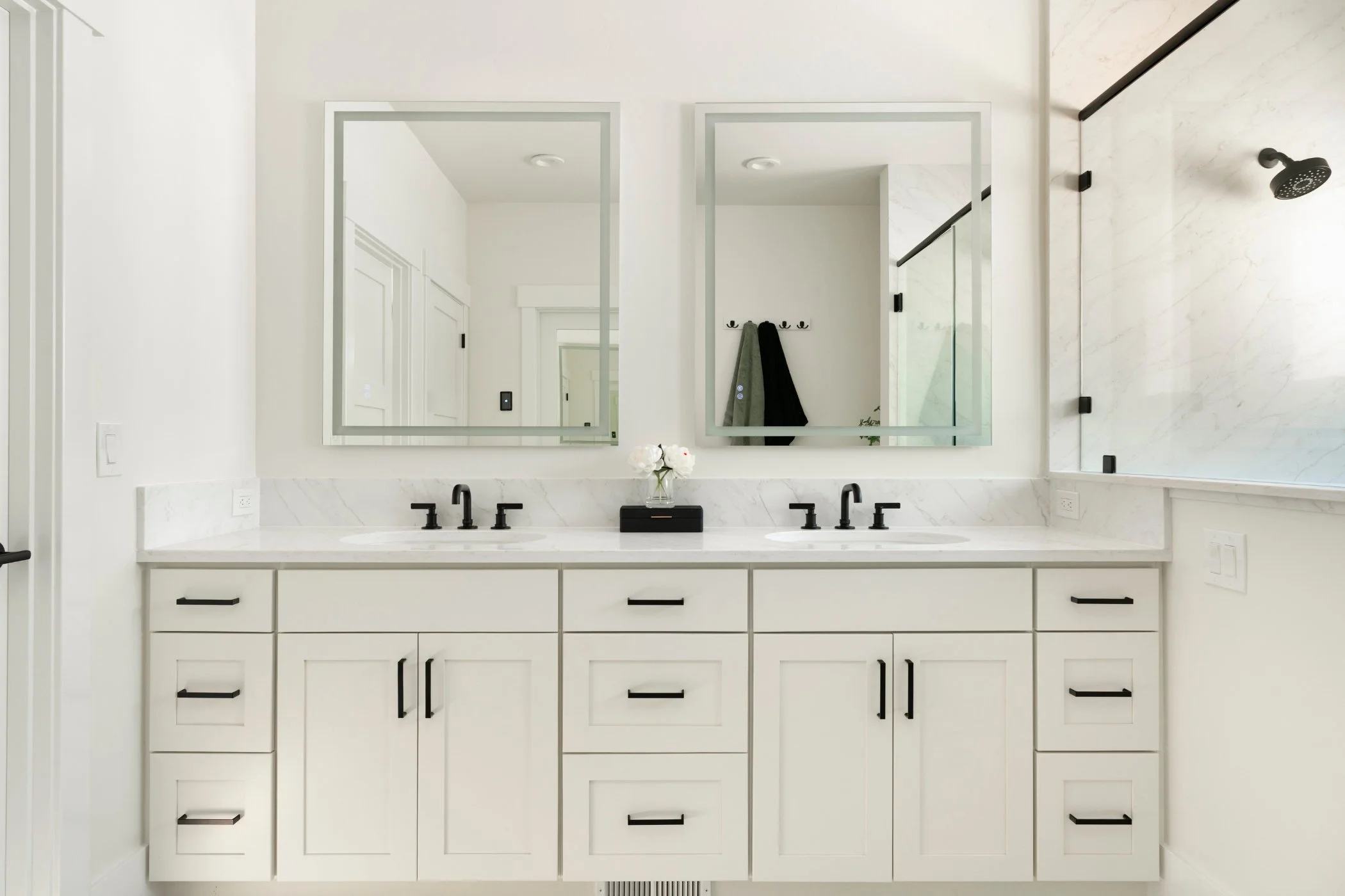 Primary bathroom with quartz slab shower, Kohler fixtures, and custom cabinetry at Sound View Estate in Olympia, WA