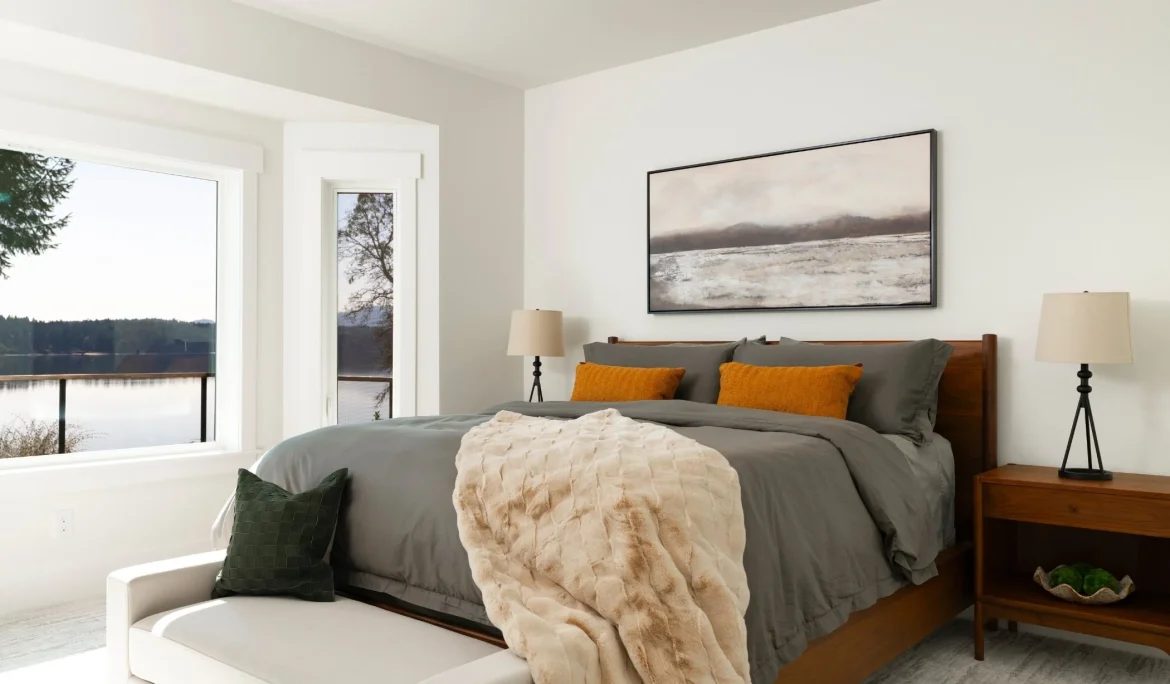 Primary bedroom with waterfront views and custom furnishings at Sound View Estate in Olympia, WA